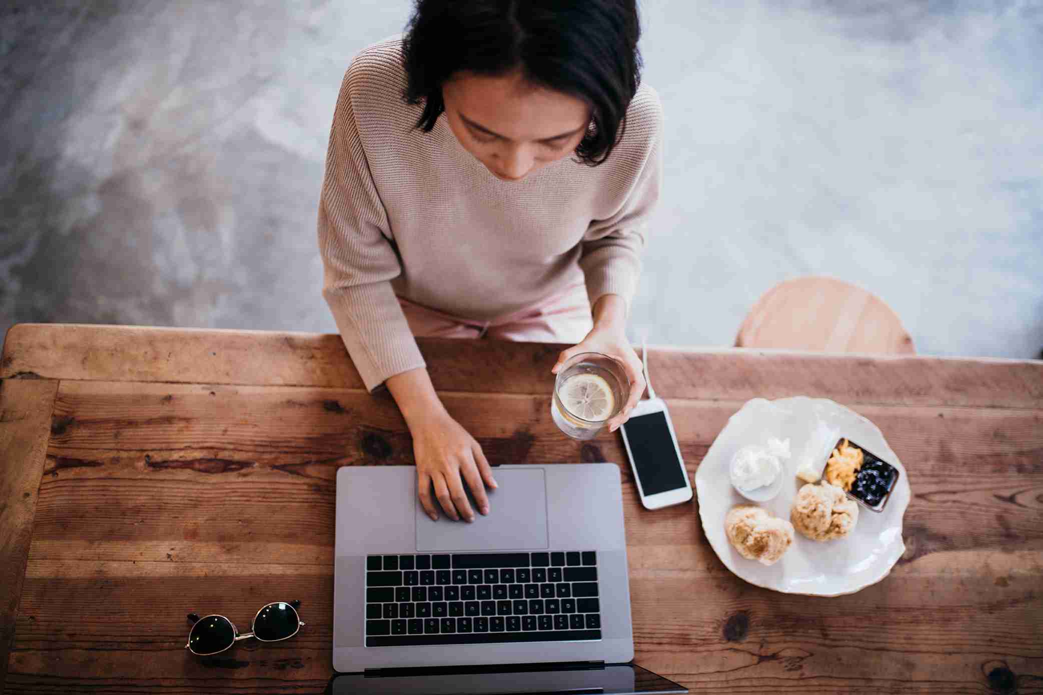 Women Having coffee and breakfast at her laptop