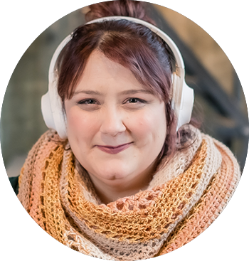 A woman wearing headphones and a scarf.
