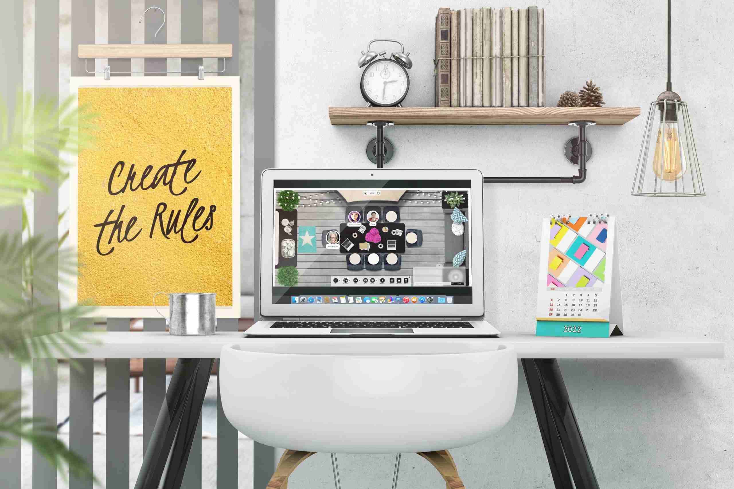 A laptop sits on a desk next to a picture of a cat.